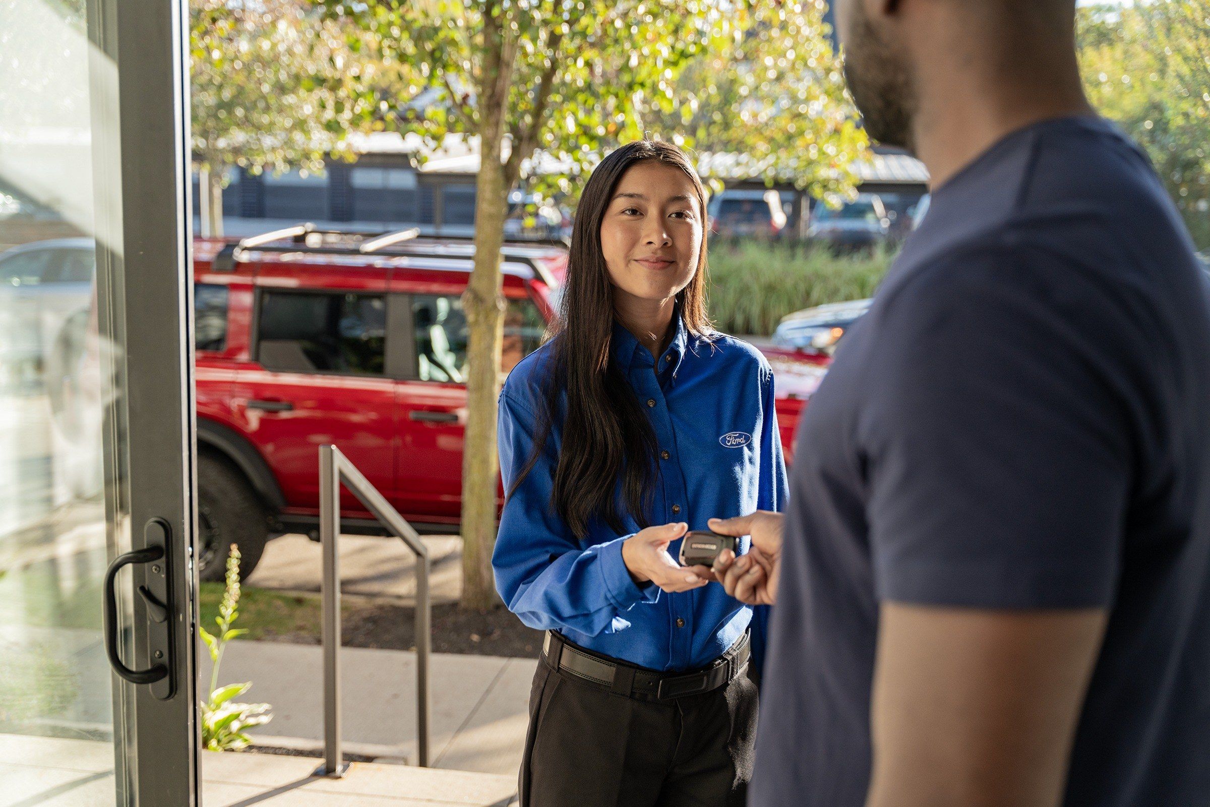 Ford advisor handing keys to a customer